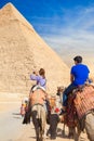 Girl rides a camel at Giza Necropolis