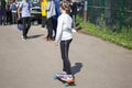 Girl rides on a skateboard. The child rides on the asphalt.