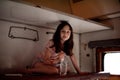 Girl in a rides in an old train. Nearby is a bottle of water Royalty Free Stock Photo