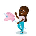 A girl rides a pink unicorn toy on a stick. The child is very happy, she smiles and waves hello.