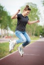 A girl rides roller skates in a city Park in summer Royalty Free Stock Photo