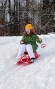 Girl rides sledge down hill Royalty Free Stock Photo