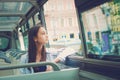 The girl rides a tourist bus.