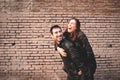 Girl riding on the back of her boyfriend laughing and having fun together as they look young and happy Royalty Free Stock Photo