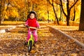 Girl riding bicycle on autumn rode Royalty Free Stock Photo