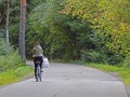 A girl riding a bicycle on a forest road
