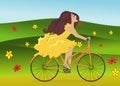 Girl is riding bike on flowering spring field Royalty Free Stock Photo