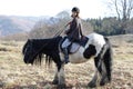 Girl riding a black and white spotted gypsy vanner horse Royalty Free Stock Photo