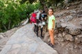 Girl riding a donkey to visit Cave of Diktaion Andron