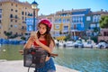 Girl riding a foldable e-bike in a Mediterranean marina