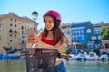 Girl riding a foldable e-bike in a Mediterranean marina