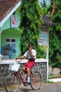 Girl riding her bicycle bike in Indonesia Royalty Free Stock Photo