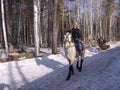 a girl riding a horse rides in the Park in winter