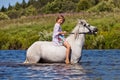 Girl riding a horse in a river Royalty Free Stock Photo