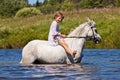 Girl riding a horse in a river Royalty Free Stock Photo