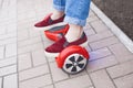 Girl riding on modern red electric mini segway or hover board scooter Royalty Free Stock Photo