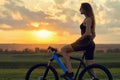 A girl riding a mountain bike on an asphalt road, beautiful portrait of a cyclist Royalty Free Stock Photo