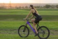 A girl riding a mountain bike on an asphalt road, beautiful portrait of a cyclist Royalty Free Stock Photo