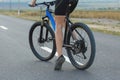 A girl riding a mountain bike on an asphalt road, beautiful portrait of a cyclist Royalty Free Stock Photo