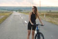 A girl riding a mountain bike on an asphalt road, beautiful portrait of a cyclist Royalty Free Stock Photo