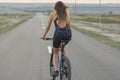 A girl riding a mountain bike on an asphalt road, beautiful portrait of a cyclist Royalty Free Stock Photo