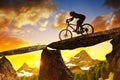 Girl riding a mountain bike at sunset.