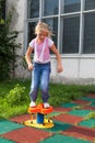 Girl riding rides on a child playground