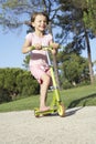 Girl Riding Scooter In Park Royalty Free Stock Photo