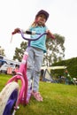 Girl Riding Scooter Whilst On Family Camping Holiday Royalty Free Stock Photo