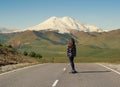 Girl Riding on skateboard on Road to Elbrus