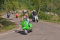 Girl riding vintage scooter Vespa