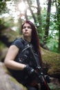 Girl with rifle in the forest.Selective focus