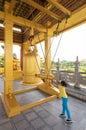 Girl rings bell at buddhist temple