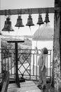 Girl rings bell tower of the old Russian Orthodox Church Royalty Free Stock Photo