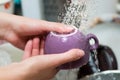 Girl rinses a cup under running water