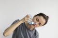 Girl rinses her nose with saline solution at home Using Neti Pot. Treatment and prevention of colds. How to rinse your