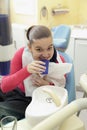 Girl rinsing mouth after dental inspection Royalty Free Stock Photo