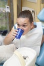 Girl rinsing mouth after dental inspection Royalty Free Stock Photo