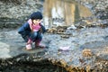 Girl on the river bank plays Paper Boat