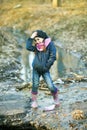 Girl on the river bank plays Paper Boat