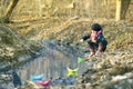 Girl on the river bank plays Paper Boat