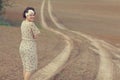 Girl on the road in field Royalty Free Stock Photo