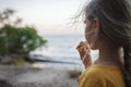 Girl roasting marshmallow to make smores over fire flame during camping, traditional travel food Royalty Free Stock Photo