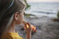 Girl roasting marshmallow to make smores over fire flame during camping, traditional travel food Royalty Free Stock Photo