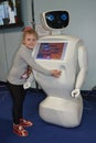 A girl at the Robostars interactive robot exhibition hugs a robot