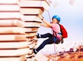 Girl rock climb on the mountain of knowledge books