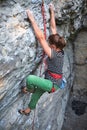 Girl rock climber climbing challenging route on the cliff Royalty Free Stock Photo