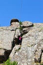 Girl rock climber climbs on a rock