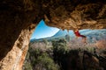 girl rock climber climbs a rock against the backdrop of a forest and blue mountains. climber goes through a difficult route using Royalty Free Stock Photo