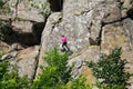 Girl rock climber climbs on a rock